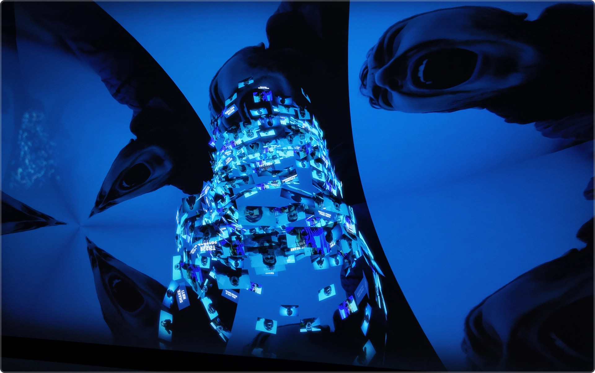 Ω: blue distorted cylindrical structure with camera imagery. Artwork by Jeanyoon Choi.