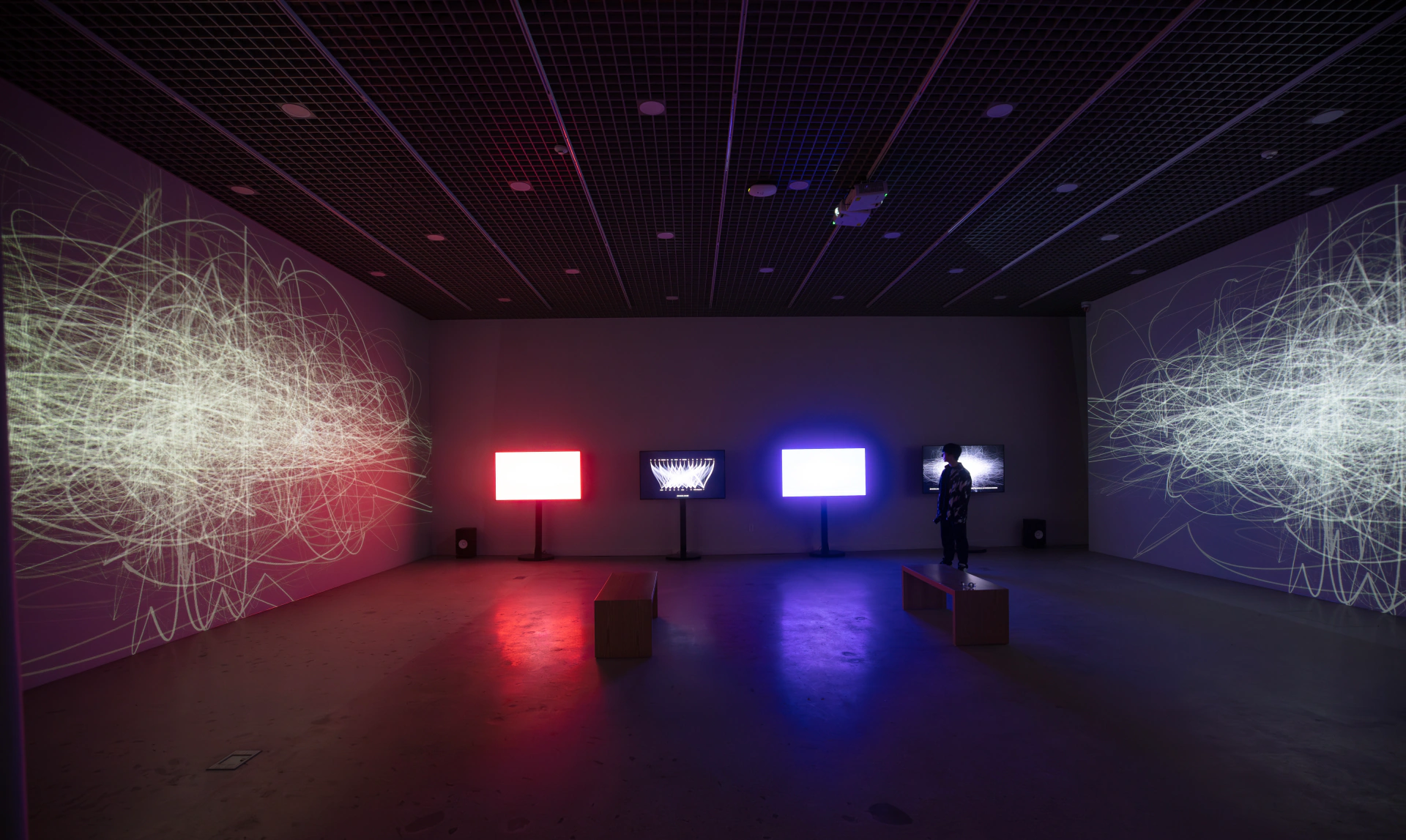 SoTA: installation view with red and blue screens between large projections. Artwork by Jeanyoon Choi, Euan Kang, SeJoon Park, Minhyeok Seo, Prof. Yiyun Kang.